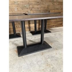 Three dark walnut rectangular console restaurant tables, on black metal bases