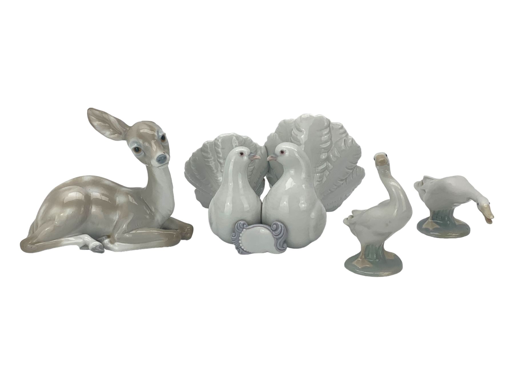 Seven Lladro figures including group of two doves, rooster, boy with accordion, deer, dove in flight , two geese and two Nao figures