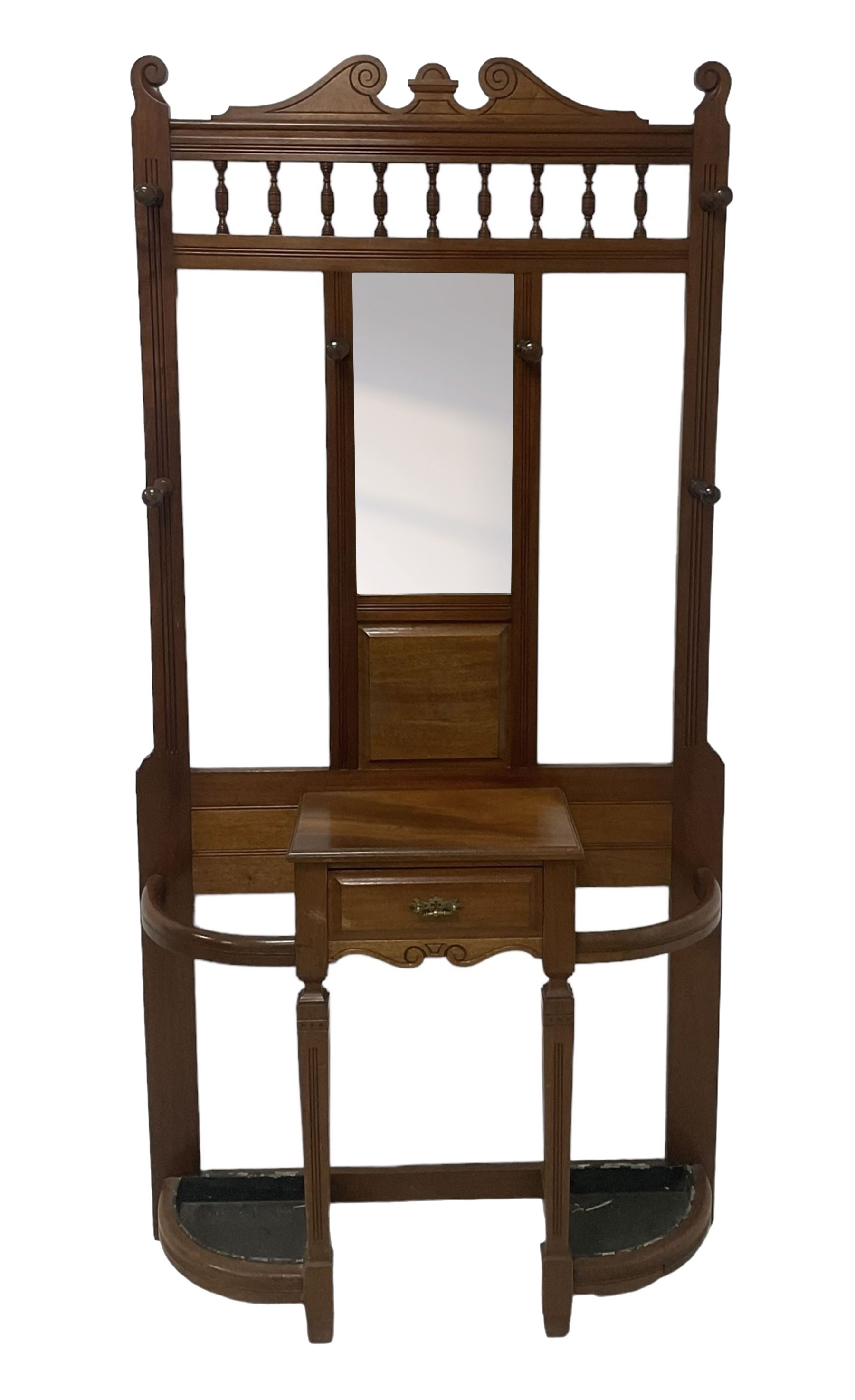 Late Victorian hallstand, raised pediment over balustrade frieze, bevelled mirror back with coat hooks over glove drawer, fitted with two drip-trays to base