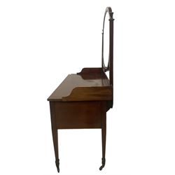 Edwardian inlaid mahogany kneehole dressing table, raised shaped oval bevelled mirror back, fitted with five drawers with banding and stringing, on square tapering supports with castors