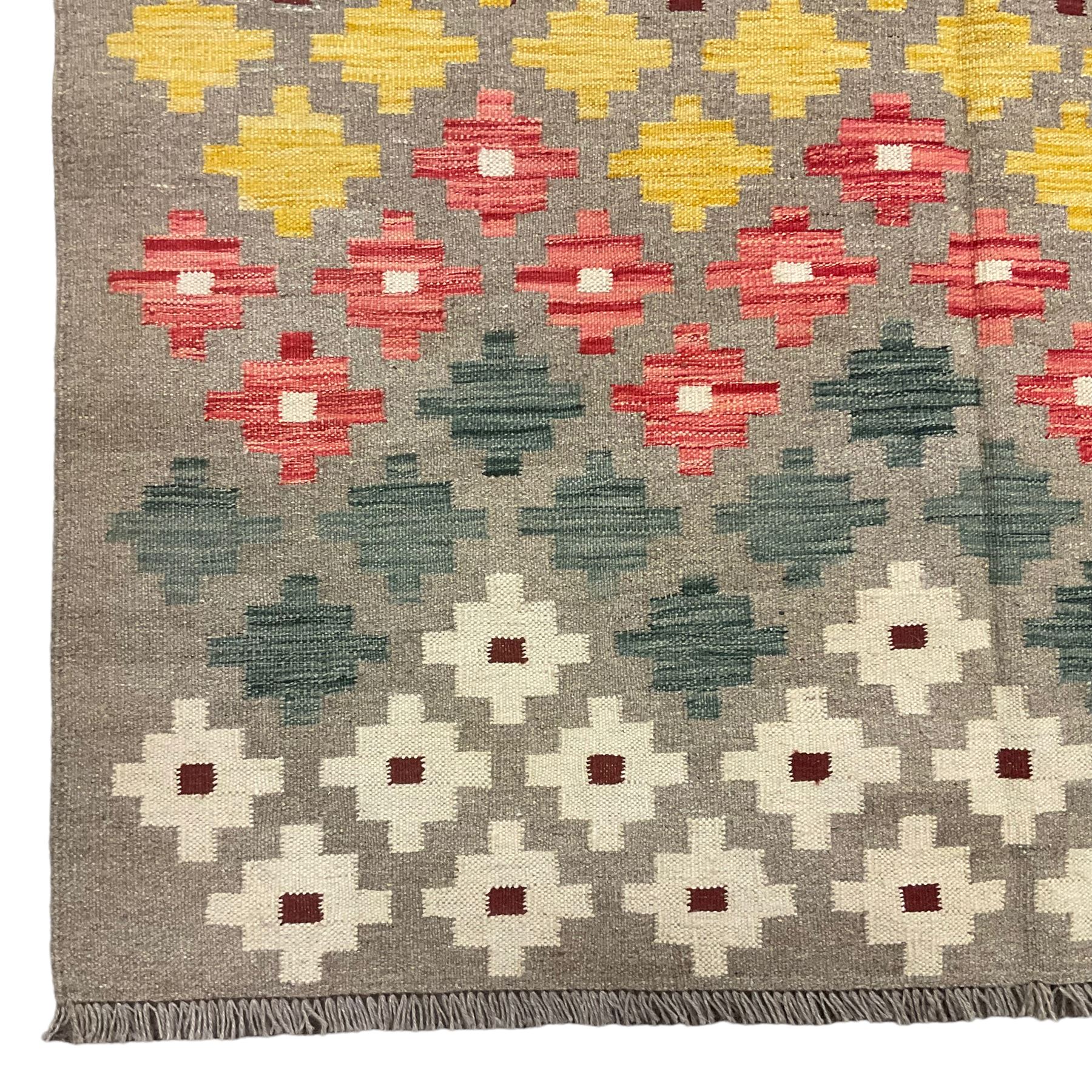 Anatolian Turkish kilim, light grey ground and decorated with multi-coloured geometric star motifs