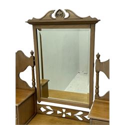 Late Victorian satin walnut dressing table, central mirror with carved crest flanked by two adjustable side mirrors, each supported by turned uprights, the base fitted with two short over two long drawers with brass handles, resting on bracket feet