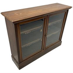 Phillips & Sons Ltd Bristol - Victorian mahogany glazed bookcase, projecting moulded cornice over two glazed doors, enclosing two shelves with scalloped edging, raised on a plinth base