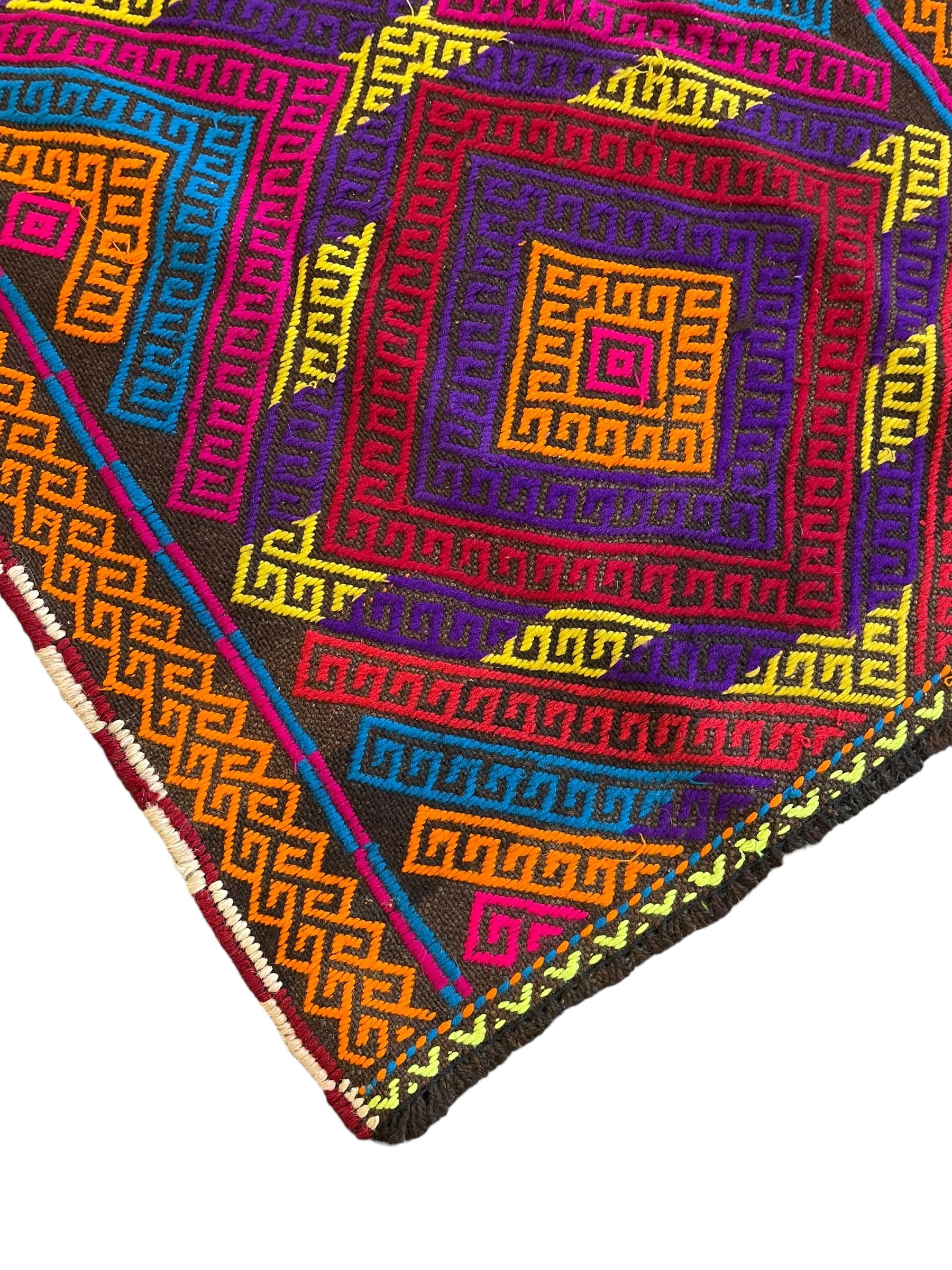 Flatweave geometric design runner rug, decorated with trailing lozenges decorated with hooked motifs, within zig-zag bands, bright multi-coloured ground 