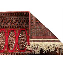 Persian Bokhara dark amber round rug, crimson field with six Gul motifs, surrounded by a guarded border with geometric design (124cm x 70cm); together with another similar in amber and red (101cm x 63cm) (2)