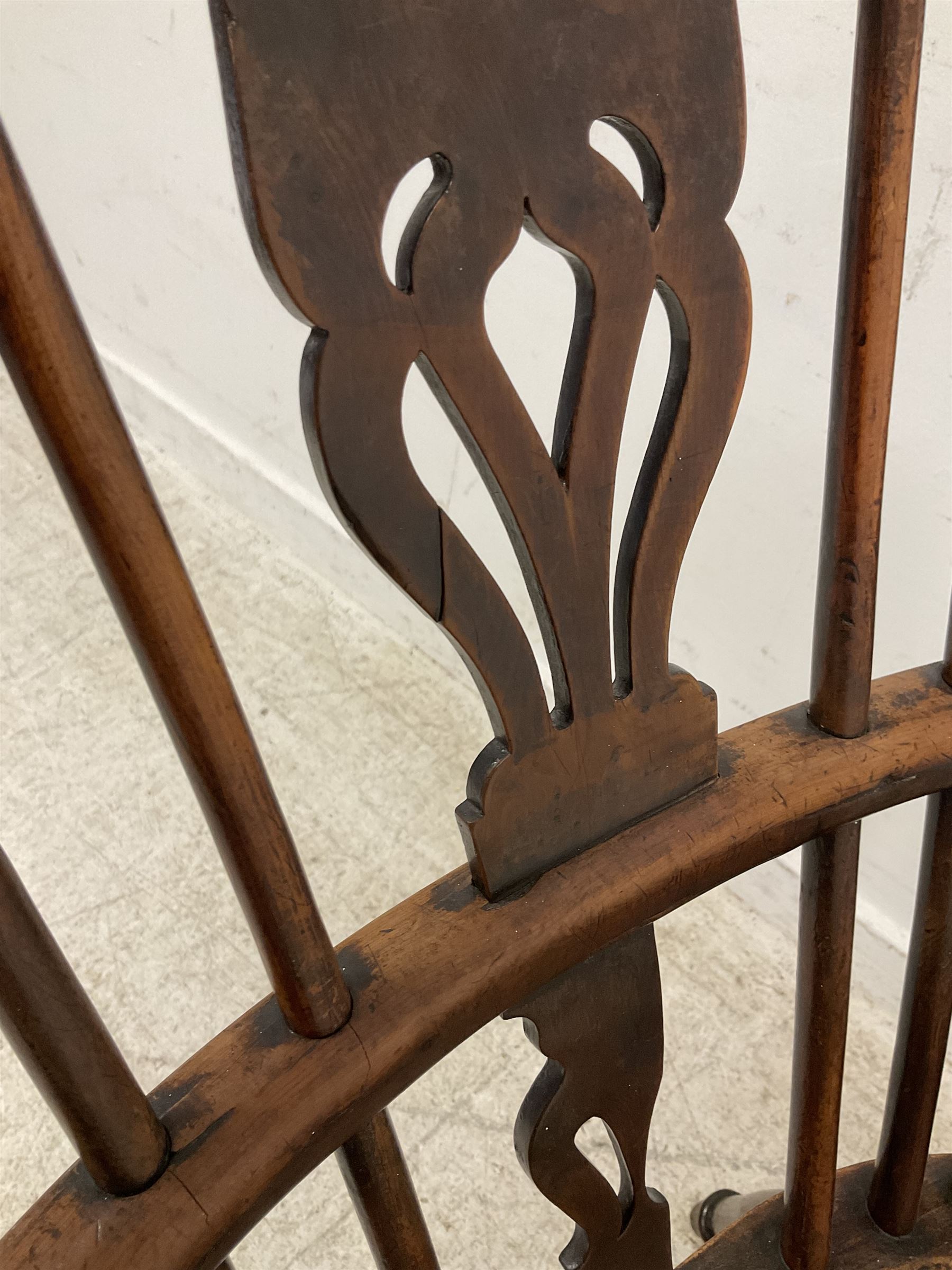 19th century yew wood and elm Windsor chair, low hoop stick back with pierced splat, dished seat raised on ring turned supports joined by crinoline stretcher