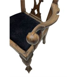 Unusual 18th century mahogany elbow chair, the shaped cresting rail with projecting shell carved ears, pierced and scroll carved splat over drop-in upholstered seat, shaped arms with ball and claw carved terminals, the seat rails carved with shell cartouches, on foliate carved cabriole supports with ball and claw feet 