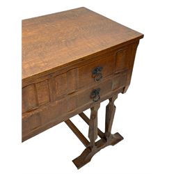 Arts & Crafts design oak chest on stand, rectangular top over two short and one long drawer, on a series of shaped and tapered supports with carved and beaded decoration, united by chamfered stretchers rails, on sledge feet 