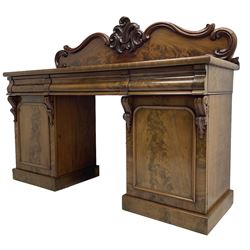 Victorian mahogany twin pedestal chiffonier, raised back with decorated with scrolling foliate motifs, fitted with three cushion drawers, the arched panelled pedestals enclosing shelves and sliding trays