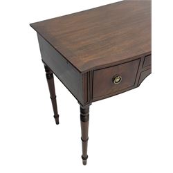 George III mahogany kneehole dressing or writing table, stepped bow-front form, reed moulded top with mahogany crossband, fitted with three cock-beaded drawers with circular pressed brass handle plates decorated with urn and beaded ring handle, on ring turned supports 