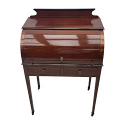 Edwardian inlaid mahogany roll-top desk, cylindrical lid enclosing fitted interior with pigeonholes, drawers and retractable writing surface, over two drawers with brass pull handles, on tapered supports with brass and ceramic castors