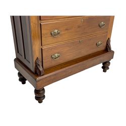 Late Victorian walnut Scotch chest, projecting cornice with turned quarter column mounts over matching half column to frieze, fitted with two upper short drawers with central cupboard, bevelled mirror glazed cupboard door, four graduating drawers below, foliage and flower head carved brackets to the uprights, panelled sides, chamfered plinth on turned feet