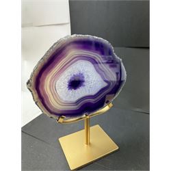 Pair of purple agate slices, polished with rough edges, raised upon gilt metal stands, H22cm