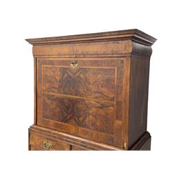 Early 18th century William & Mary figured walnut escritoire, projecting moulded cornice over shallow frieze drawer, the figured fall front enclosing interior fitted with small drawers, cupboards, pigeon holes and hidden drawers, the lower section fitted with two short and two long graduating drawers, on tall bracket feet 