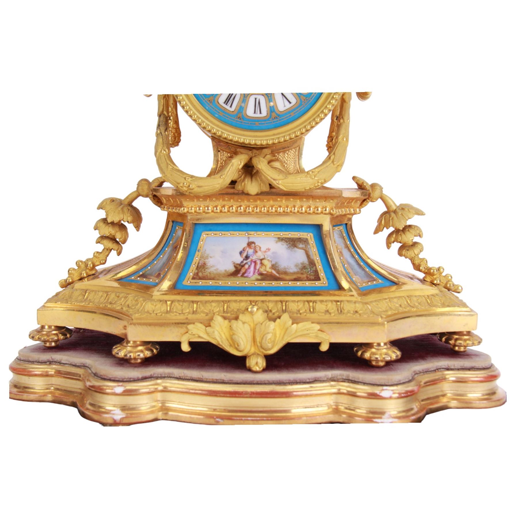 French - 19th century Sevres style porcelain inset 8-day mantle clock with an over out swept base and foliate scrolls,  porcelain panels painted with romantic scenes within gilt highlighted blue borders, dial surmounted by a conforming oval porcelain urn with side handles, blue porcelain dial with a painted centre and contrasting white cartouche Roman numerals and gilt spade hands, dial inscribed Thomas Kirk, Paris, with a rack striking twin train movement, striking the hours and half hours on a bell, mounted on a gesso padded base and ebonised plinth. With key and pendulum.