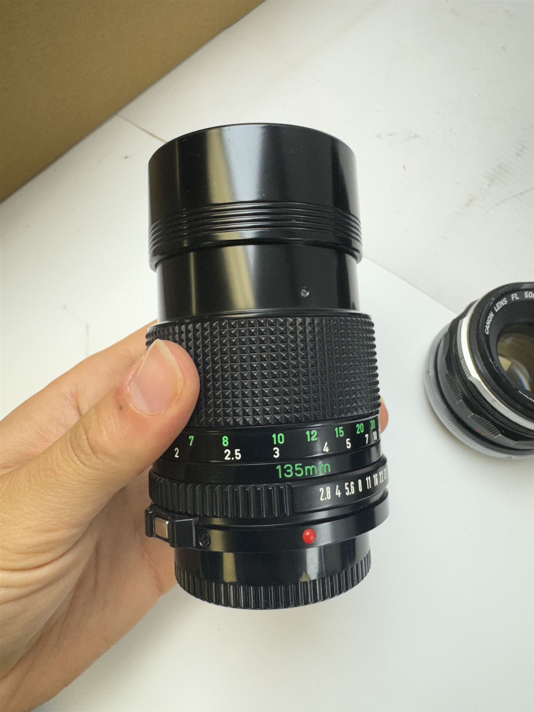 Seventeen Canon camera lenses, mostly FD examples, including 28-85mm 1:4 serial no, 49881, 35-105mm 1:3.5-4.5 serial no. 87632 and 135mm 1:2.8 serial no. 48336, one boxed