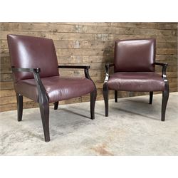 Two rosewood framed armchairs, upholstered in brown leather