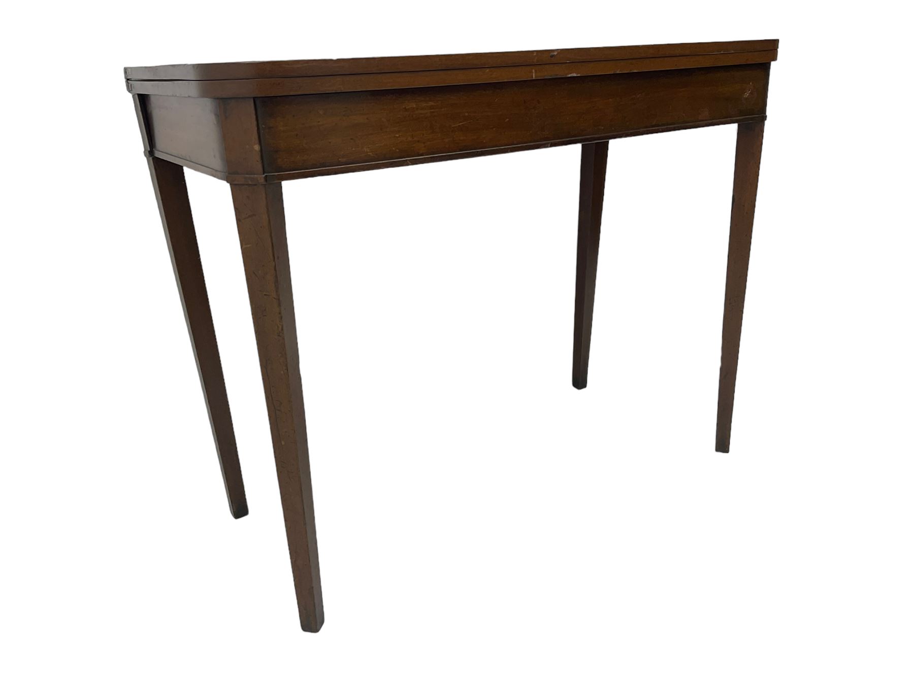 Early 20th century mahogany tea table, fold-over swivel top with rounded corners, raised on square tapering supports