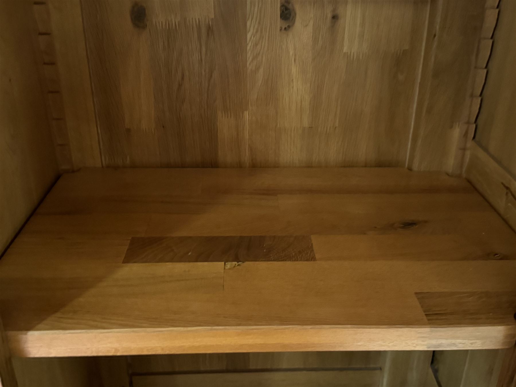 Large 20th century oak dresser, projecting cornice over open arched central section with two shelves, flanked by two panelled cupboards with two shelves, lower section with three drawers above three cupboards, on stile supports 