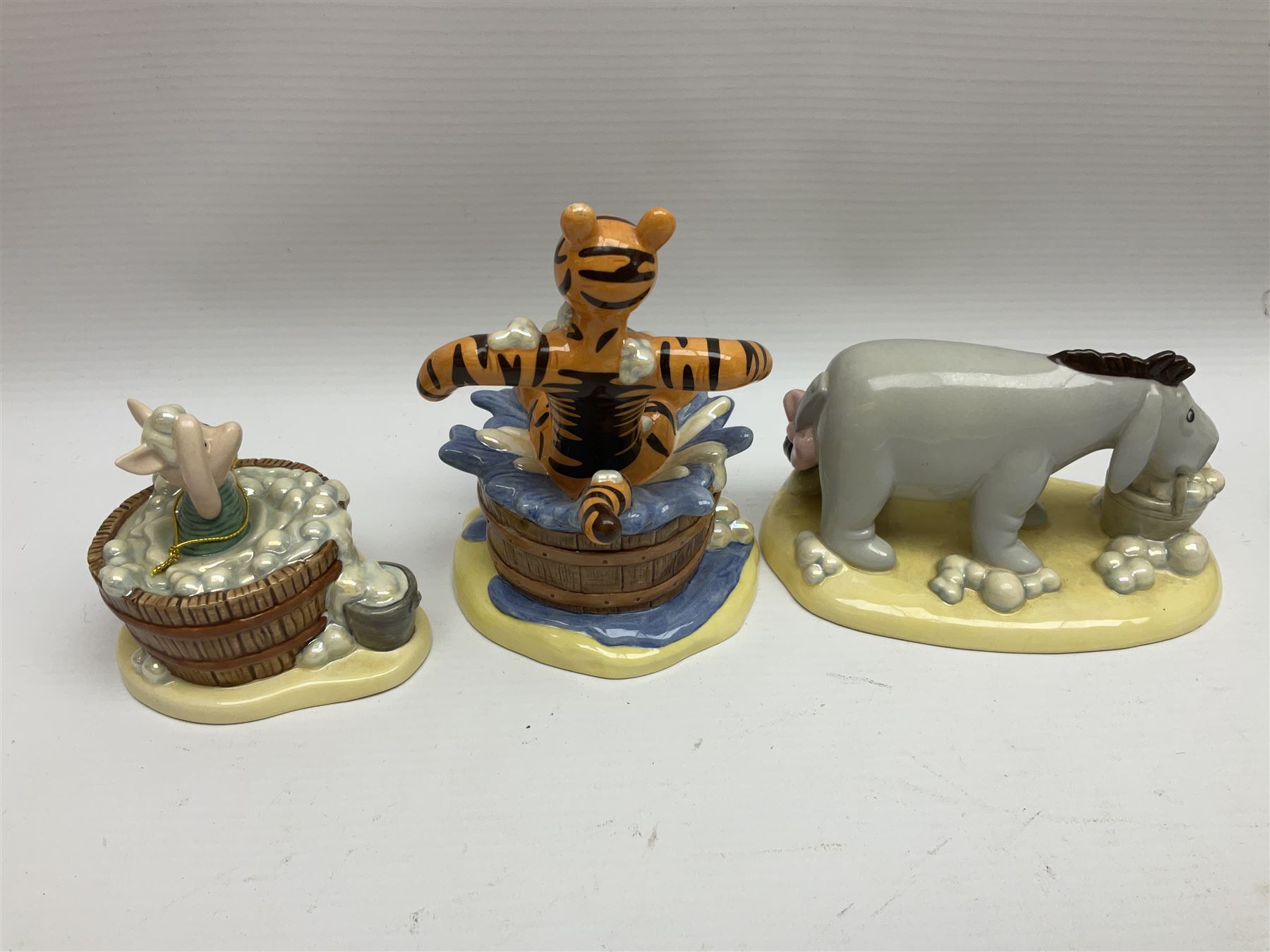 Nine Royal Doulton Winnie the Pooh Collection figures, including Oh Dear Bath Time's Here, Going Sledging, Tigger's Splash Time and Christopher Robin, together with a Royal Doulton Disney Showcase Jiminy Cricket figure, all boxed