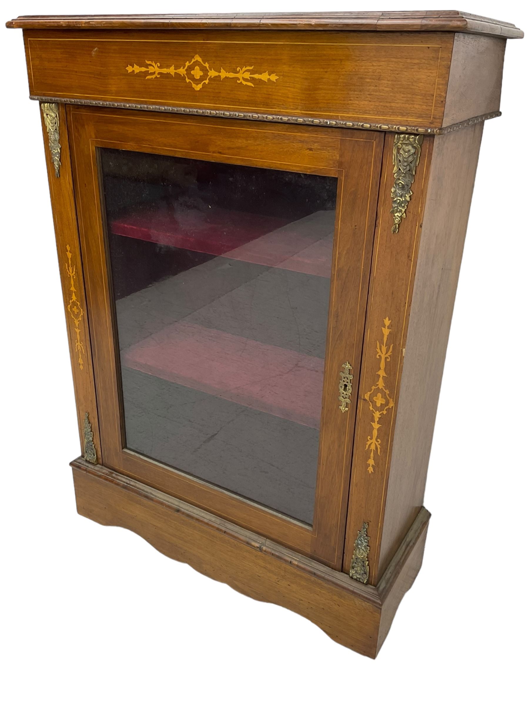 Victorian walnut pier cabinet, moulded rectangular top over inlaid frieze, enclosed by single glazed door, the uprights inlaid with extending stylised foliage decoration and cast gilt metal mounts, on moulded plinth base