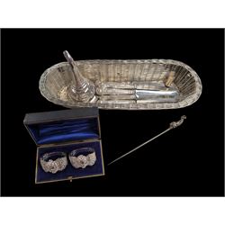 Pair of cased white metal napkin rings, together with a silver plated wine funnel, EPNS br...