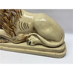 19th century salt-glazed stoneware door porter, as a recumbent lion, upon a stepped plinth base, H32