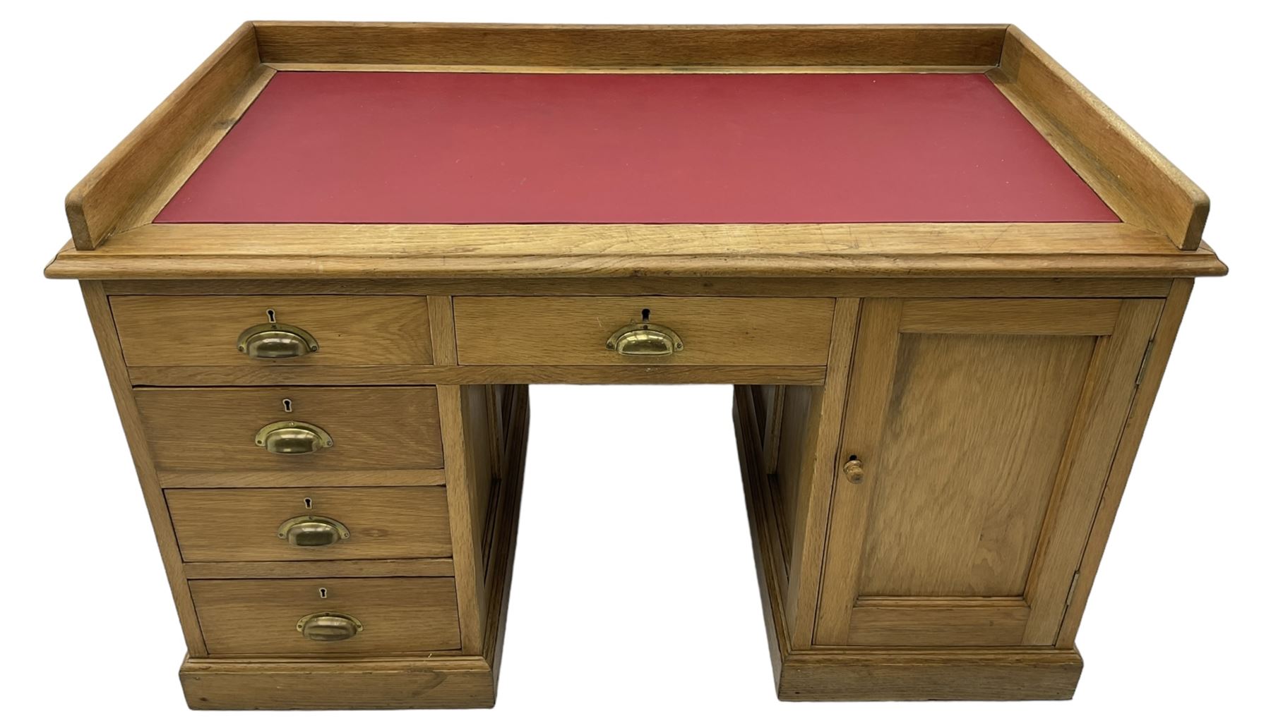 20th century oak desk, moulded rectangular top with raised back and inset leather writing surface, fitted with five drawers and single panelled cupboard, on moulded plinth base