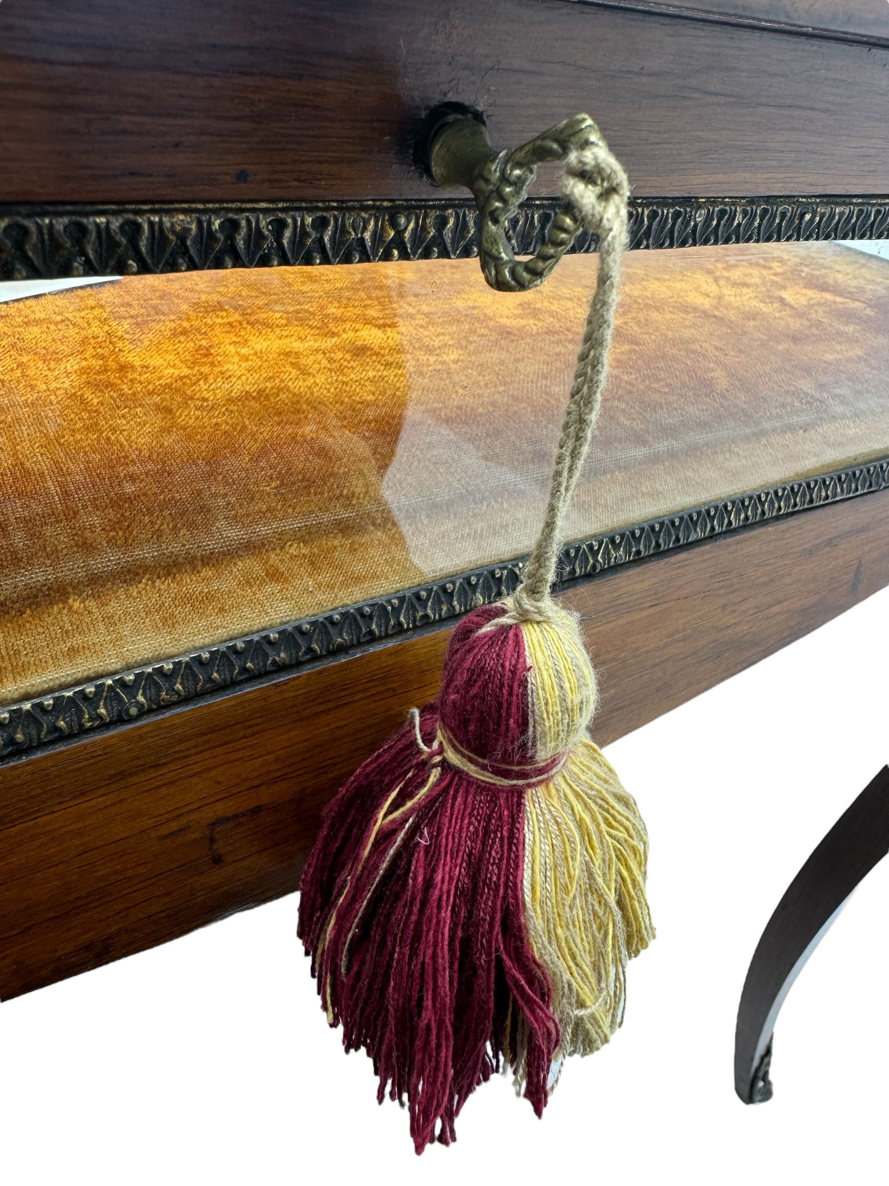 Victorian inlaid rosewood bijouterie table cabinet, shaped form, enclosed by hinged bevel glazed lid with shell and floral inlays, fabric lined interior, glazed sides within foliate cast gilt metal edging, on cabriole supports with floral cast gilt metal mounts and terminal caps 