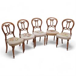 Set of five Victorian walnut balloon back dining chairs, interlaced C-scroll back over floral tapestry seat, on turned and fluted supports 