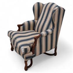 Georgian design wingback armchair, upholstered in blue and cream striped fabric, on shaped supports united by serpentine x-framed stretchers 