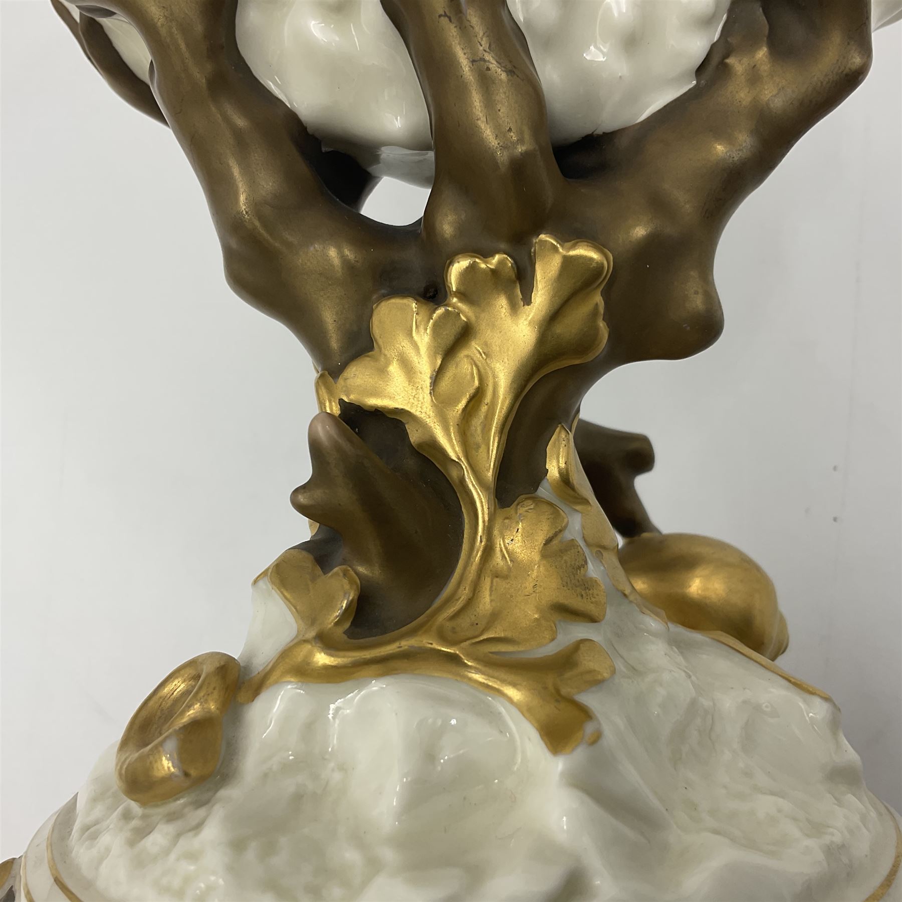 A late 19th Century Royal Worcester vase modelled as a nautilus shell surmounted by a gilt lizard, raised upon a naturalistically modelled gilt coral stem, and spreading base detailed with sea shells and formal shell border to edge, with puce mark beneath with date cypher for 1887, and impressed mark, H22cm

