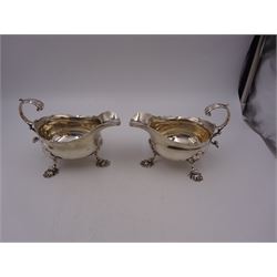 Near pair of George II silver sauce boats, each of oval form with shaped rim and capped flying scroll handle, upon three scroll mounted feet, hallmarked David Hennell, London 1758, H12cm