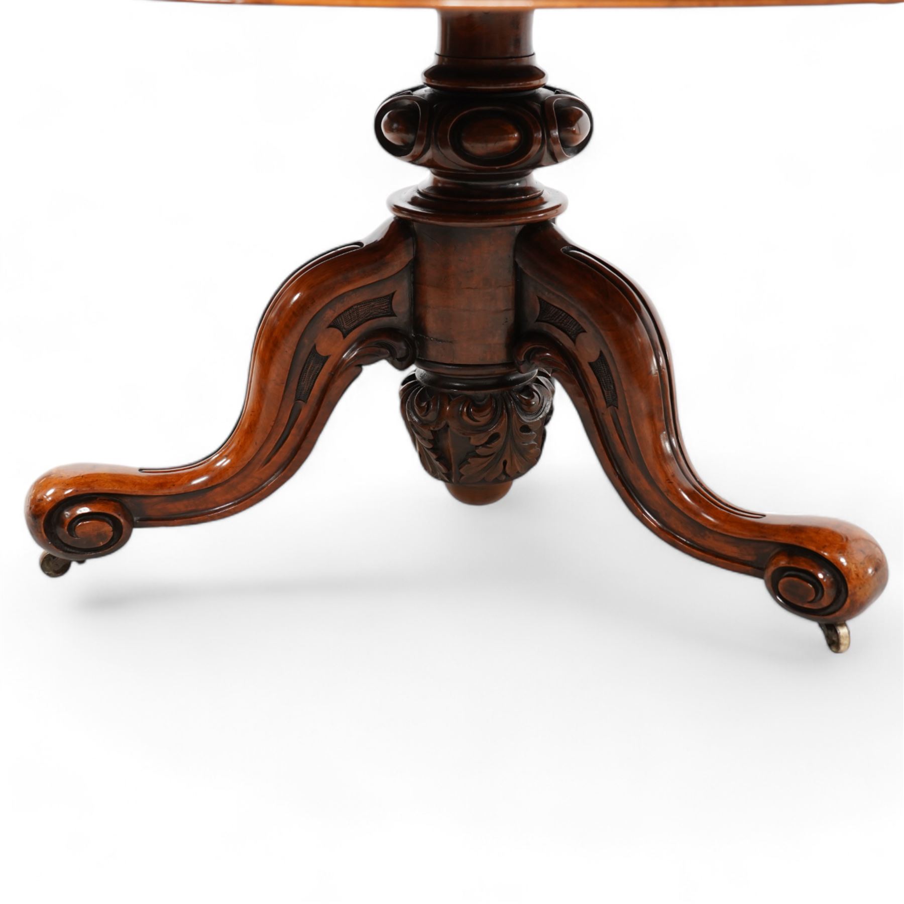 Victorian figured walnut circular centre table, moulded edge over plain frieze, raised on a turned and egg-and-dart moulded pedestal, terminating in an acanthus carved terminal and splayed supports with castors