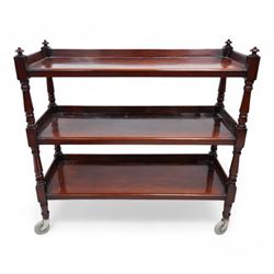 Victorian mahogany three-tier buffet, raised three-quarter gallery back with surmounted turned finials and moulded front edge, raised on turned supports and uprights terminating to castors