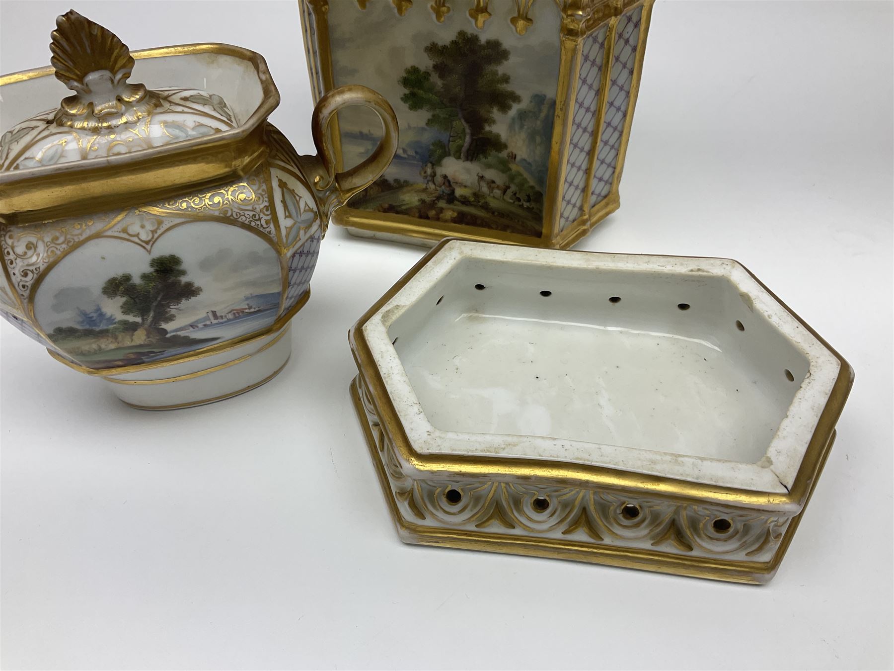 Two 19th century continental teapots and warmers, each teapot upon a hexagonal warming base, the first example painted with landscape scenes, the second with nesting birds in gilt branches, H28cm