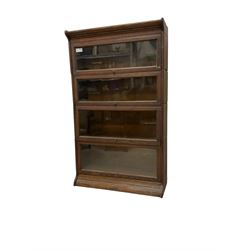 Early 20th century oak Globe Wernicke design sectional library bookcase, four sections each with hinged sliding glazed door, on moulded base 