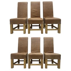 Set of six contemporary light oak dining chairs, each with high back and seat upholstered in pale tan leather, on square supports connected by H-stretcher