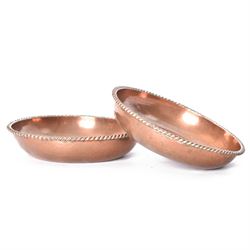 Pair of Arts & Crafts copper dishes by Gordon Russell, with lightly hammered finish and oblique gadrooned rim, impressed beneath 'Golf Hotel Grange Over Sands' and with maker's mark for Lygon