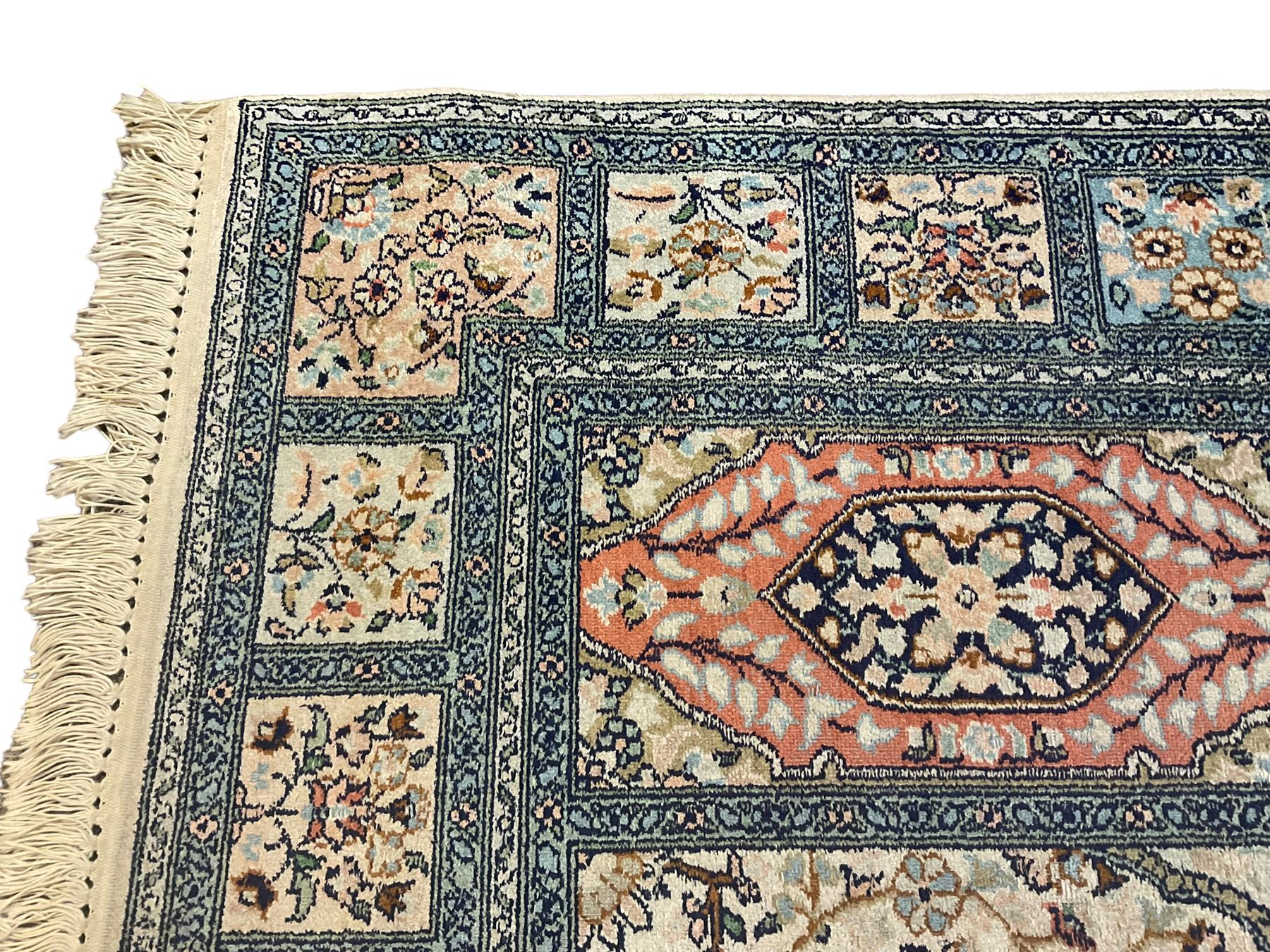 Fine Persian Kashmir ivory and pale indigo ground runner rug, the field decorated with sixteen rectangular panels depicting Mirab motifs and other traditional carpet designs, the border with repeating square panels of floral bouquets and foliate patterns