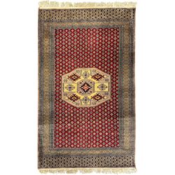 Pakistani Kashan hand-knotted rug with a central medallion and intricate geometric floral patterns, set against a red field and framed by a multi-band border; Pakistani Kashan rug with a repeating floral motif across the red field, enclosed by a detailed geometric border in complementary tones (2)