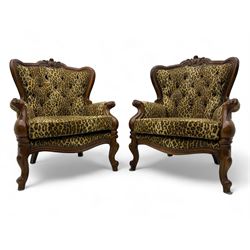 Pair of Victorian design stained beech armchairs, upholstered in leopard print fabric, with carved top rail over button-tufted backrest, scroll arms, serpentine front rail, raised on cariole supports