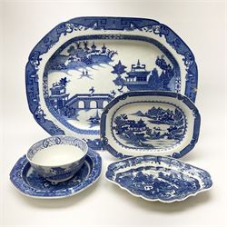 A late 18th century Caughley Salopian dessert dish decorated in the Caughley Willow pattern with a willow type landscape containing two figures in conversation within a white reserve, with printed marks verso, L26.5cm, together with a later dish decorated in a similar pattern, D23.5cm, a 19th century blue and white platter decorated in the Long Bridge pattern, L51.5cm, and two further pieces of blue and white.