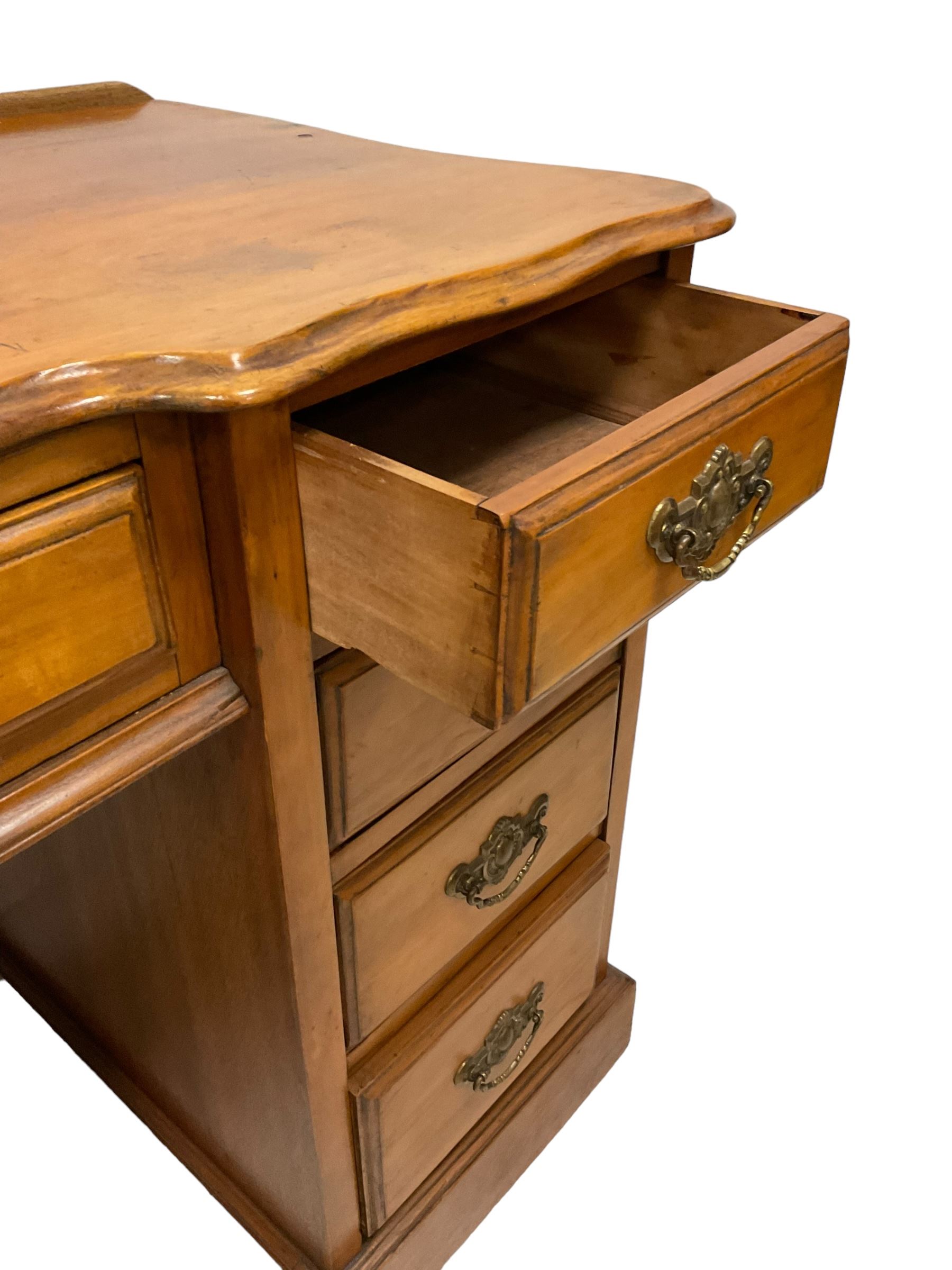 Late 19th century walnut twin pedestal desk, shaped moulded top over nine drawers, on moulded plinth base 