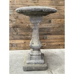 Cast stone garden bird bath, circular dished top, raised on square tapering column, on ste...