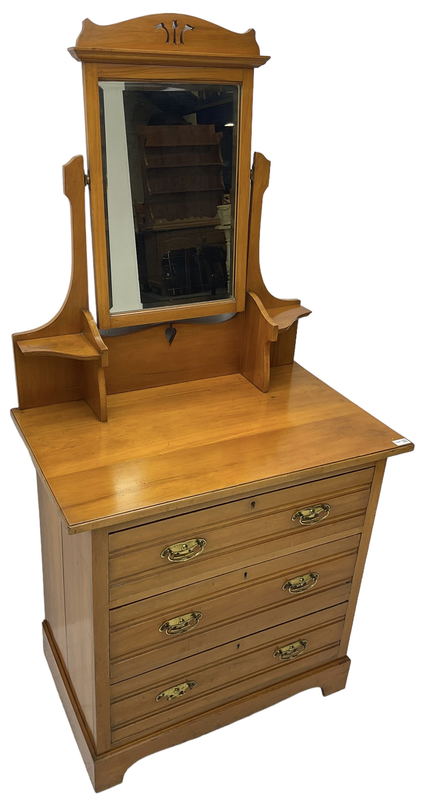 Edwardian satin walnut dressing chest, raised bevelled mirror back, the base fitted with three drawers