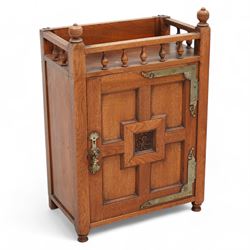 Late 19th century Aesthetic Movement walnut cupboard, raised and pierced spindle gallery surmounted by ring-turned finials, over a panelled door decorated with central foliate carved panel and surrounded by plain geometric shaped panels, applied with brass fittings and loop handle, on turned feet