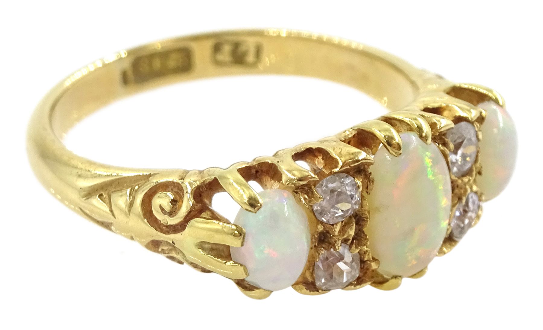 Early 20th century 18ct gold three stone opal and four stone old cut diamond ring, hallmarked