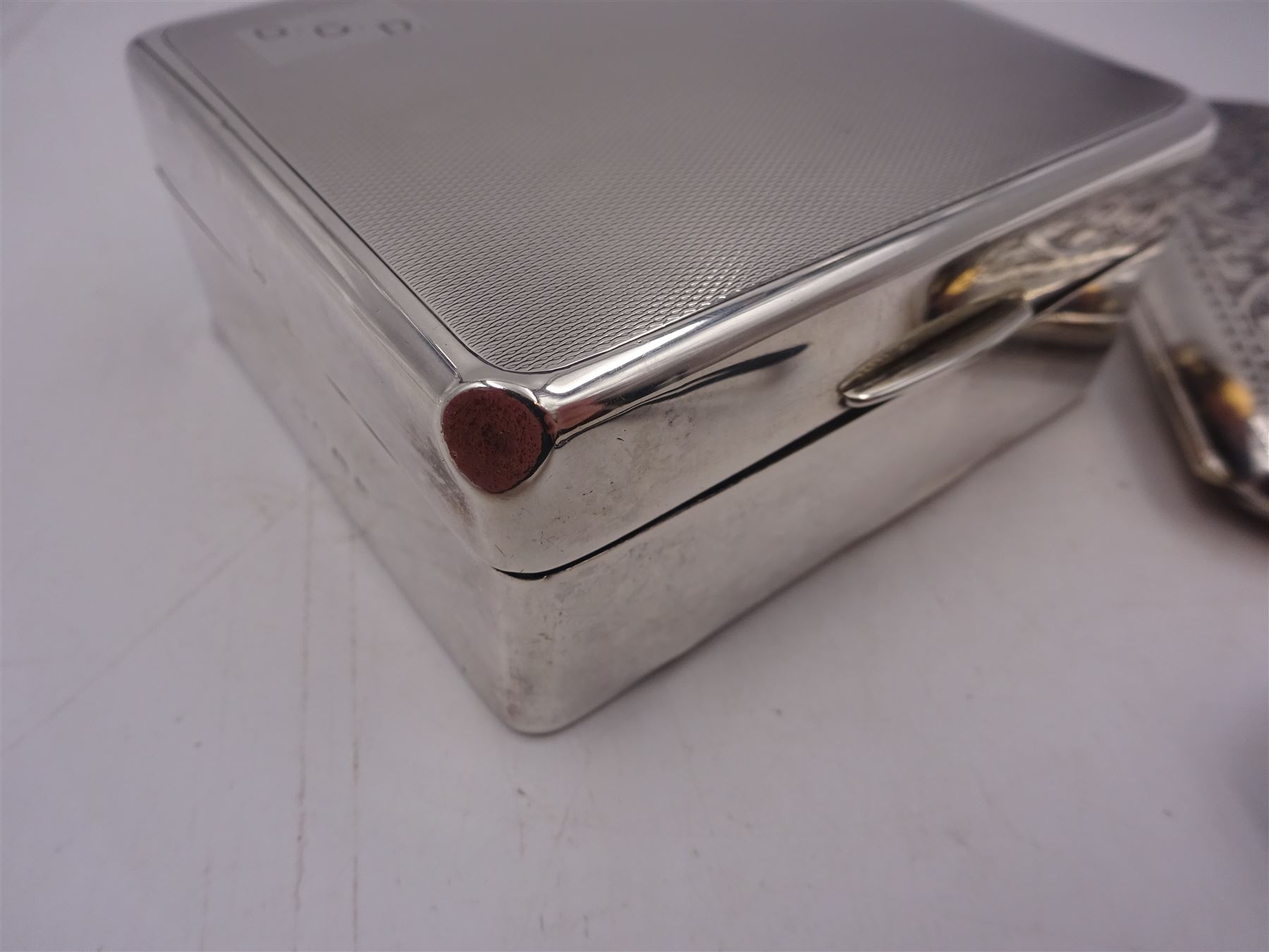 1920s silver cigarette case, of rectangular form with rounded corners, engraved with initials to front cover and scrolling decoration throughout, hallmarked John Rose Birmingham 1922, together with a 1930s silver mounted cigarette box, of plain rectangular form, with engraved initials and engine turned decoration to hinged cover, opening to reveal a softwood lined interior, hallmarked William Neale & Son Ltd, Birmingham 1939, box H3.5cm