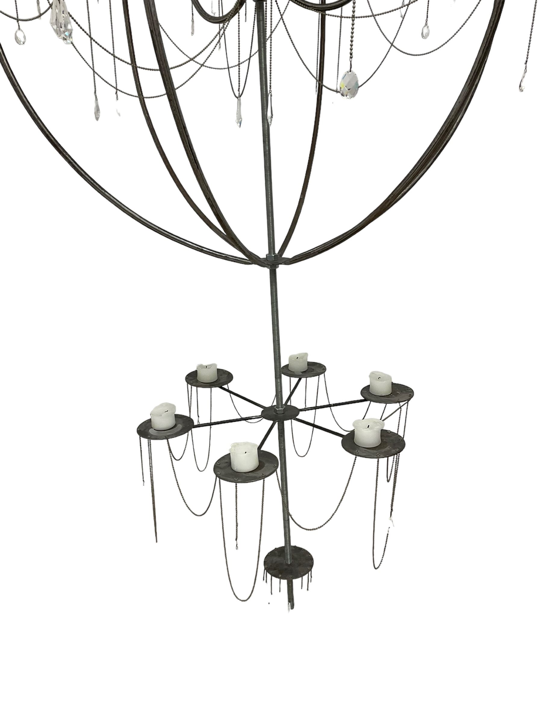 Large bespoke wrought iron cage candle chandelier, the top tier with six extending branches over bell-shape cage with scrolled supports and six branches, six branch lower tier; together with ceiling winch 